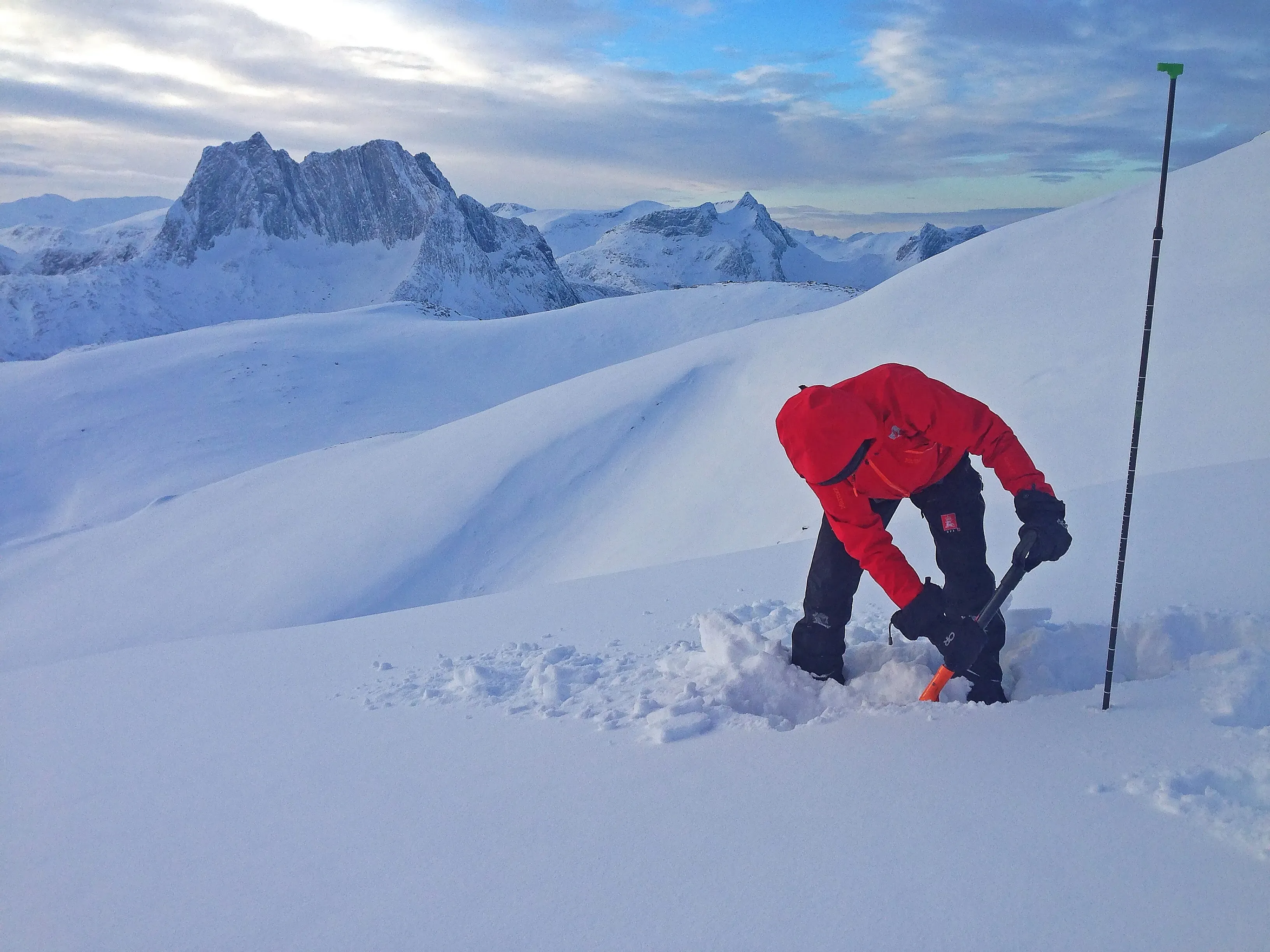 A course-trained skier digging a snowpit in the backcountry